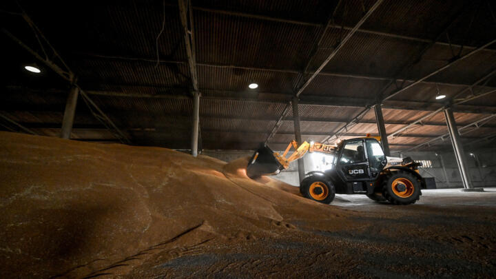 An agricultural worker operates inside a grain storage during a wheat harvesting in Zaporizhzhia region, Ukraine, July 14, 2023.